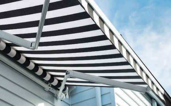 Folding arm awning over a patio